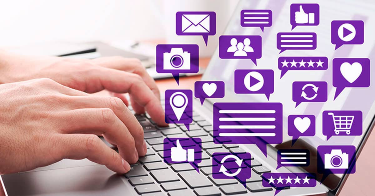 Chat bubbles over a person typing on a laptop showing how busy social media can lead to mistakes from the Social Media Mistakes: How to Respond When Social Media Goes Wrong article by Design At Work