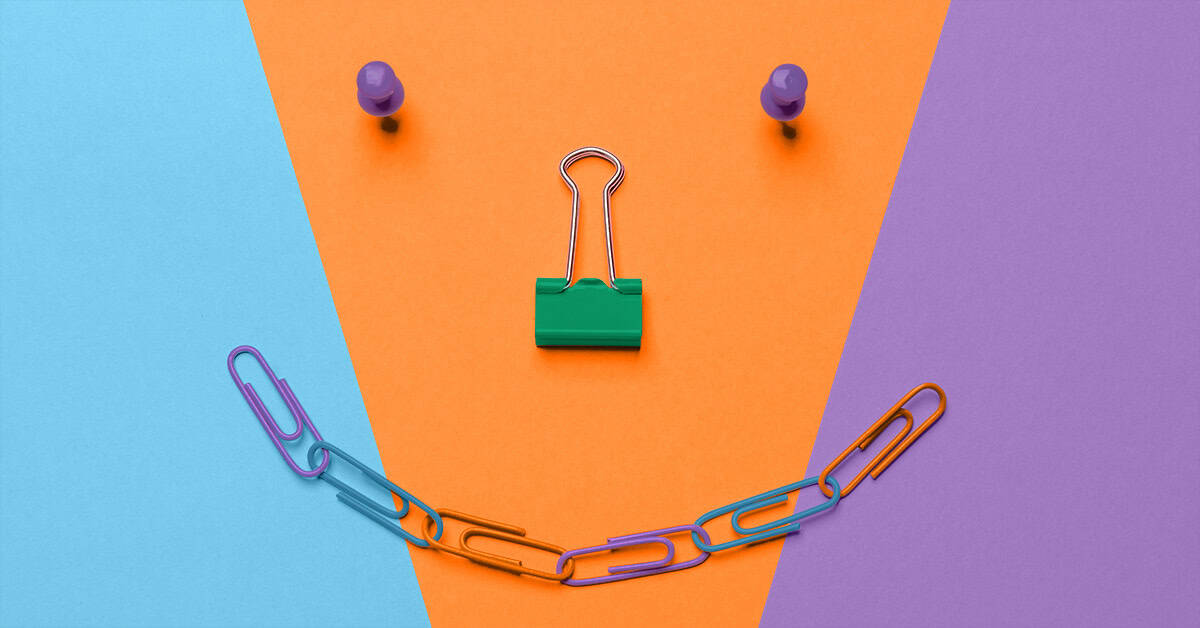 office clips and push pins in a smile shape showing how internal marketing improves workplace